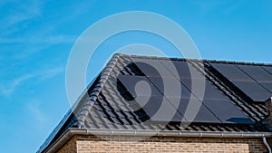 Newly build houses with solar panels attached on roof against a sunny sky Close up of solar pannel