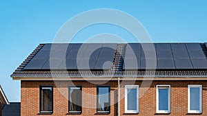 Newly build houses with solar panels attached on roof against a sunny sky Close up of solar pannel