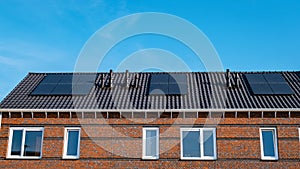 Newly build houses with solar panels attached on roof against a sunny sky Close up of solar pannel