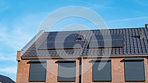 Newly build houses with solar panels attached on roof against a sunny sky Close up of solar pannel