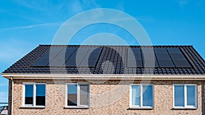 Newly build houses with solar panels attached on roof against a sunny sky Close up of solar pannel