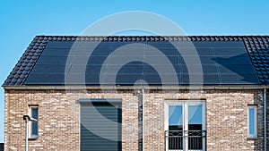 Newly build houses with solar panels attached on roof against a sunny sky Close up of solar pannel