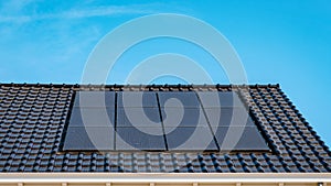 Newly build houses with solar panels attached on roof against a sunny sky Close up of solar pannel