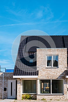 Newly build houses with solar panels attached on roof against a sunny sky Close up of solar pannel