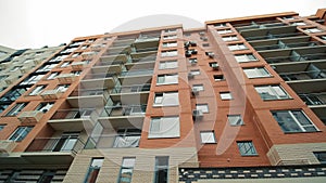 Newly built modern multi-storey residential, apartment building with baskets for air conditioning on the facade and