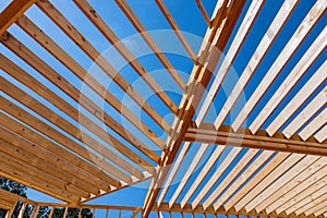 In a newly built wooden house, framing beams support the layout of the joists.