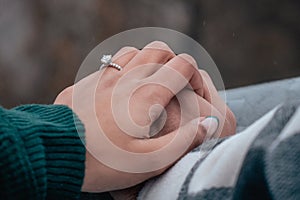 Newly Engaged Couple Showing off Engagement Ring in Winter Wonderland