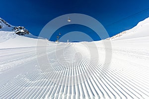 Newly groomed ski slope on a sunny day