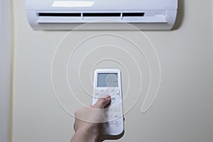 Newly installed air conditioner hanging on the beige wall of new apartment