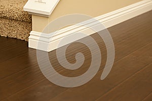 Newly Installed Brown Laminate Flooring and Baseboards in Home photo