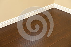 Newly Installed Brown Laminate Flooring and Baseboards in Home