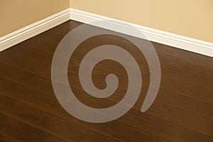 Newly Installed Brown Laminate Flooring and Baseboards in Home