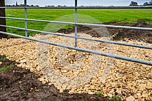 Newly laid hardcore rubble seen at the entrance to a farm field.