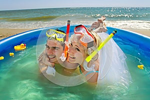 Newly-married couple enjoying on the beach