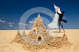 Newly-married couple enjoying o the beach