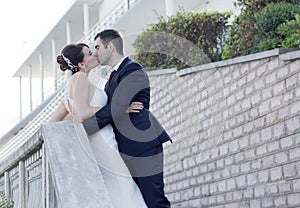 Newly Married Couple Kissing Outdoors