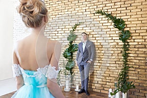 Newly married couple, loving couple before the wedding. Man and woman loving each other. Bride in the turquoise dress and groom