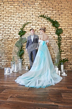 Newly married couple, loving couple before the wedding. Man and woman loving each other. Bride in the turquoise dress and groom