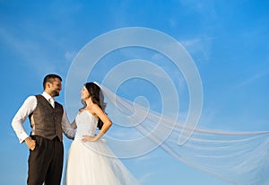 Newly married couple portrait with blue sky