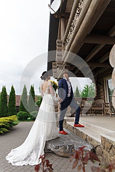 Newly married ready to enter in luxurious wooden mansion