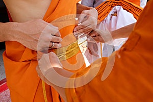 Newly ordained Buddhist monk pray with priest procession