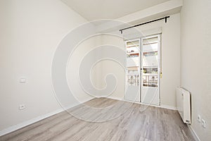 Newly painted room with bay window, wooden floors, radiator and black