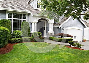 Newly painted and stained exterior of modern home during summertime