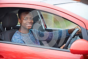 Newly Qualified Teenage Boy Driver Sitting In Car