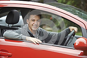 Newly Qualified Teenage Boy Driver Sitting In Car photo