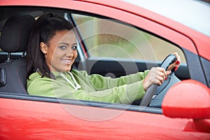 Newly Qualified Teenage Girl Driver Sitting In Car