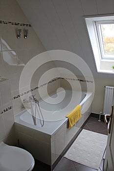 a newly renovated attic bathroom with great mosaic tiles and a beautiful cream color