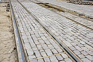 Newly replaced tram tracks and intermediate track surface, historic cube-shaped granite cobblestones