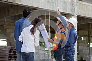 Newly wed couple is meeting with engineering contractor at their under construction house to inspect the building progress and