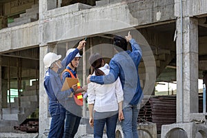 Newly wed couple is meeting with engineering contractor at their under construction house to inspect the building progress and