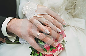 Newly wed couple`s hands with wedding rings