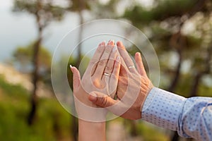 Newly wed couple`s hands with wedding rings