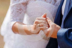 Newly wed couple`s hands with wedding rings