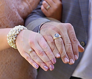 Newly wed couple& x27;s hands with wedding rings