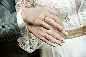 Newly wed couple`s hands with wedding rings