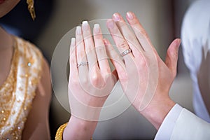 Newly wed couple`s hands with wedding rings