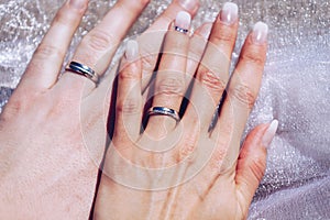 Newly wed couple`s hands with wedding rings