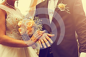 Newly wed couple`s hands with wedding rings. Vintage tone