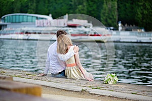 Newly-wed couple sitting on the Seine embankment