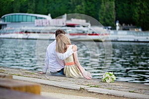 Newly-wed couple sitting on the Seine embankment photo