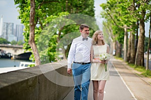 Newly-wed couple walking together in Paris