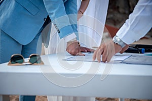 Newly wedded couple making wedding documents official by putting thumbprint