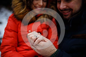 Newly weds holding hands and showing wedding rings