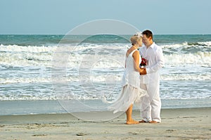 Newly weds near the ocean