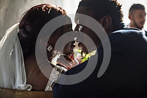 Newlywed African Descent Bride Kissing Groom Wedding Celebration