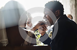 Newlywed African Descent Couple Kissing Hands